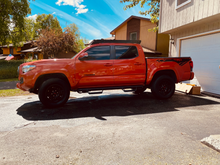 Load image into Gallery viewer, Side view of Economy Roof Rack with amber light baron a red Toyota Tacoma - Cali Raised LED