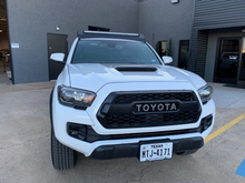 Load image into Gallery viewer, Front view of Economy Roof Rack on a white Toyota Tacoma - Cali Raised LED
