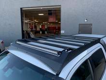 Load image into Gallery viewer, Top view of Economy Roof Rack on a white Toyota Tacoma - Cali Raised LED
